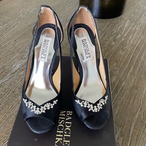 Black satin “Foxy” platform heels.